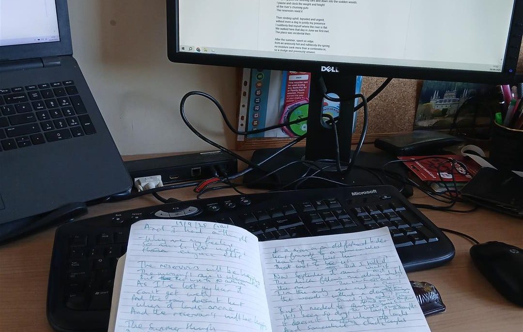 Notebook in front of computer